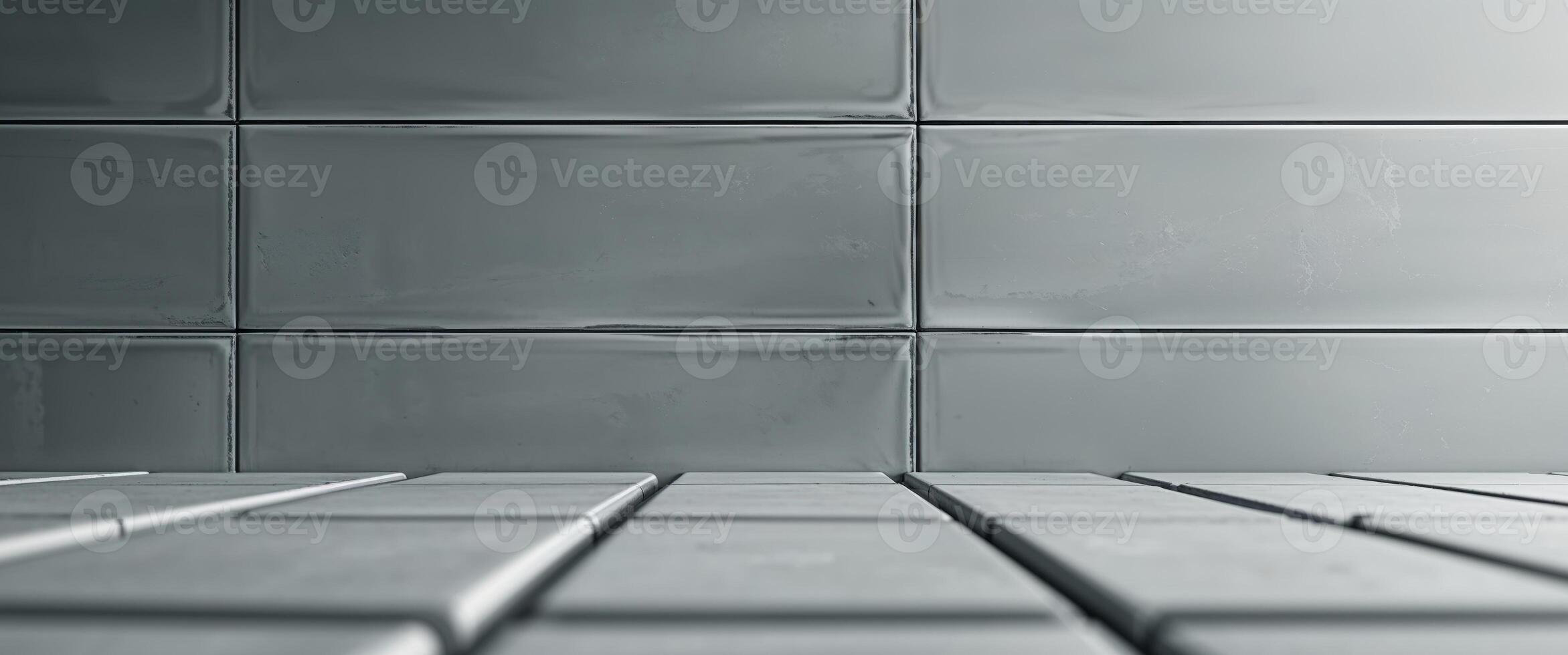 Decorative rectangular wall tiles in a muted gray tone. photo