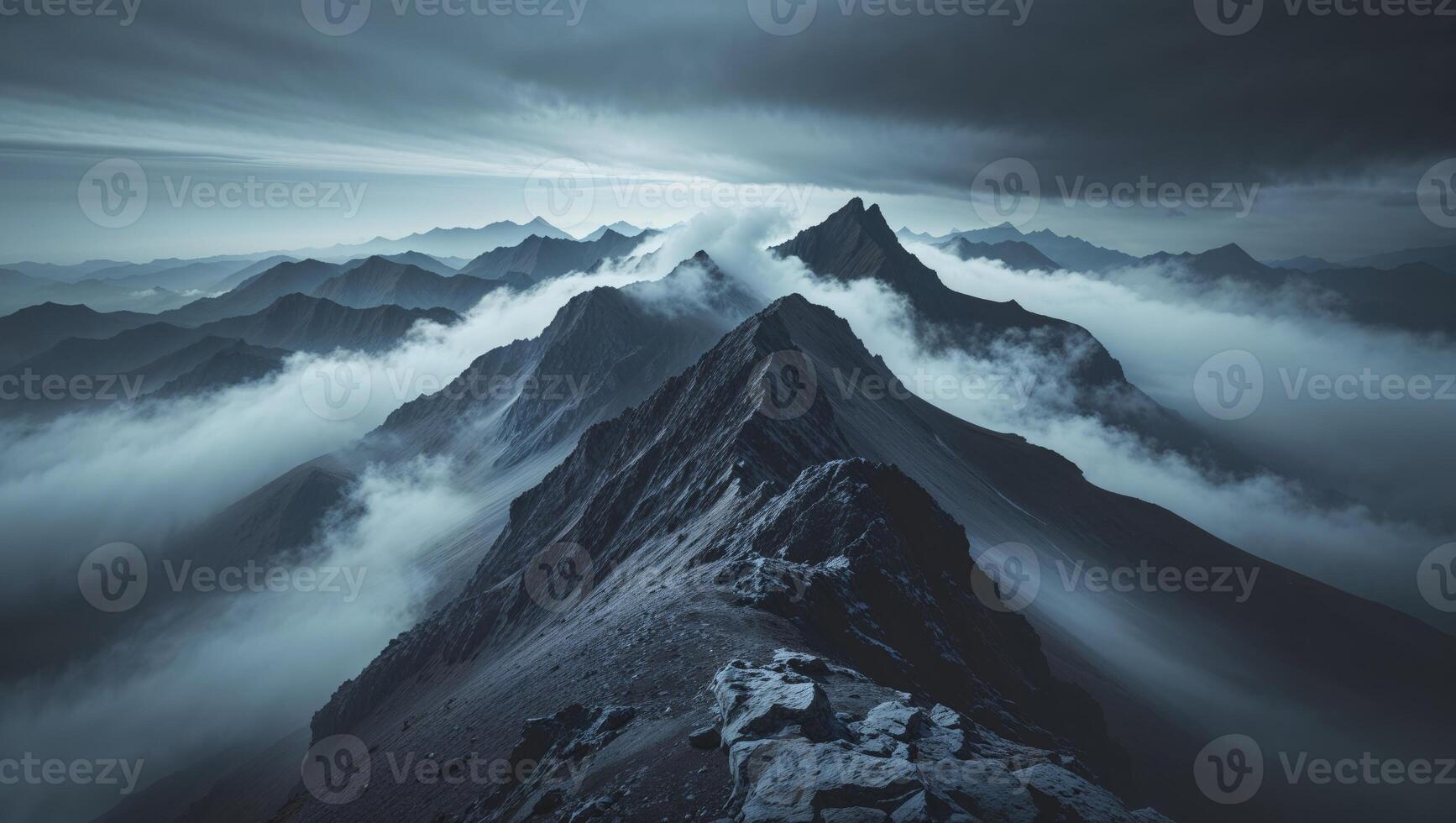 A mountain range is shown with clouds and dark clouds photo