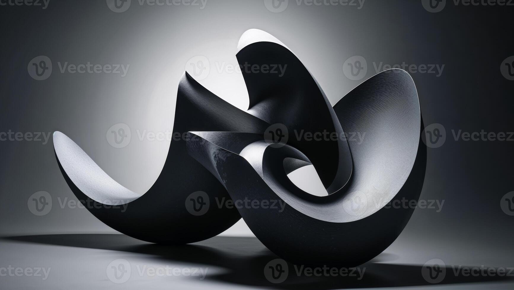 A black sculpture with curved shapes on a gray background photo