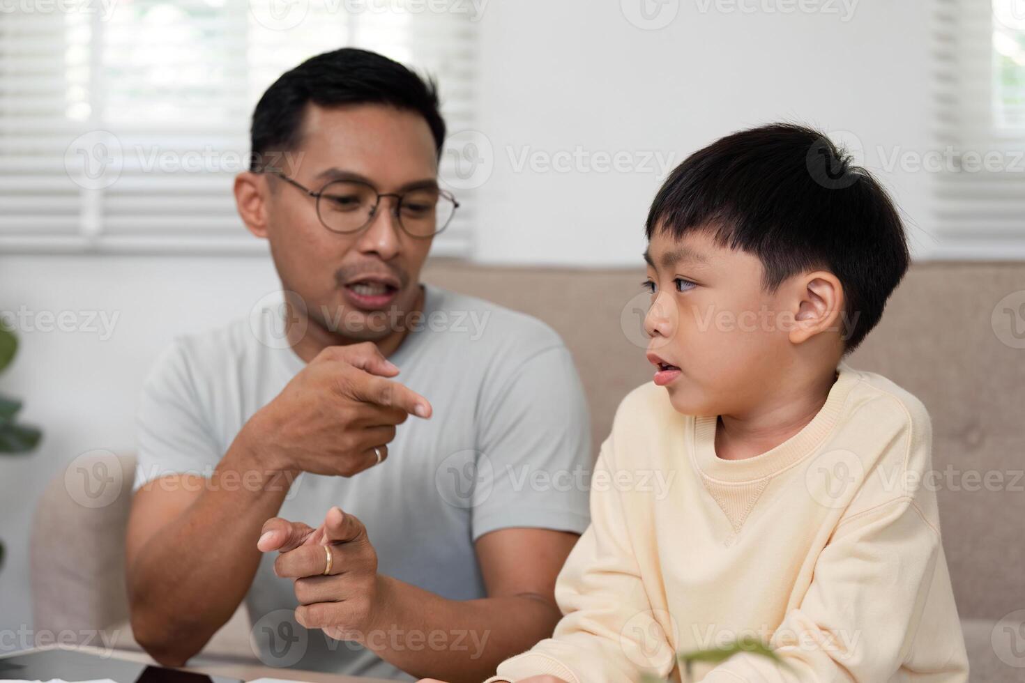 Homeschooling sessions with father teaching math to son photo
