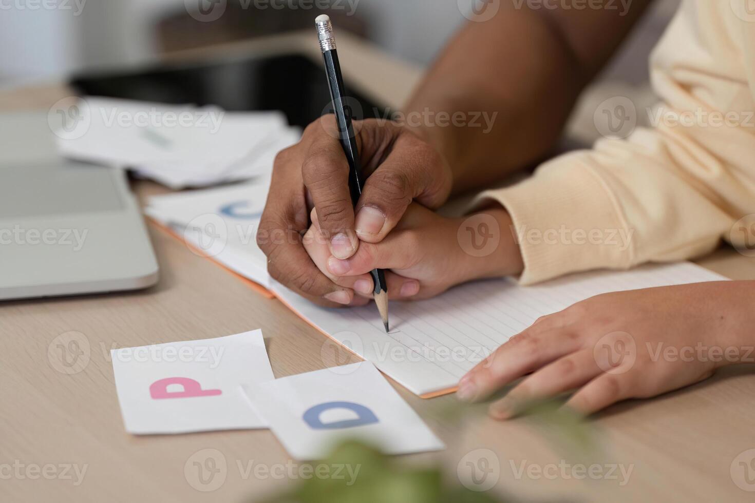 Homeschool writing exercise with father and son working together photo