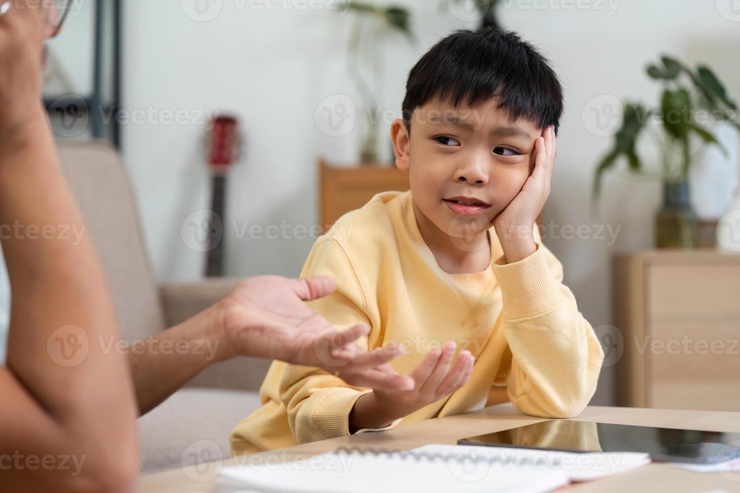 Homeschooling interaction between father and son at home photo