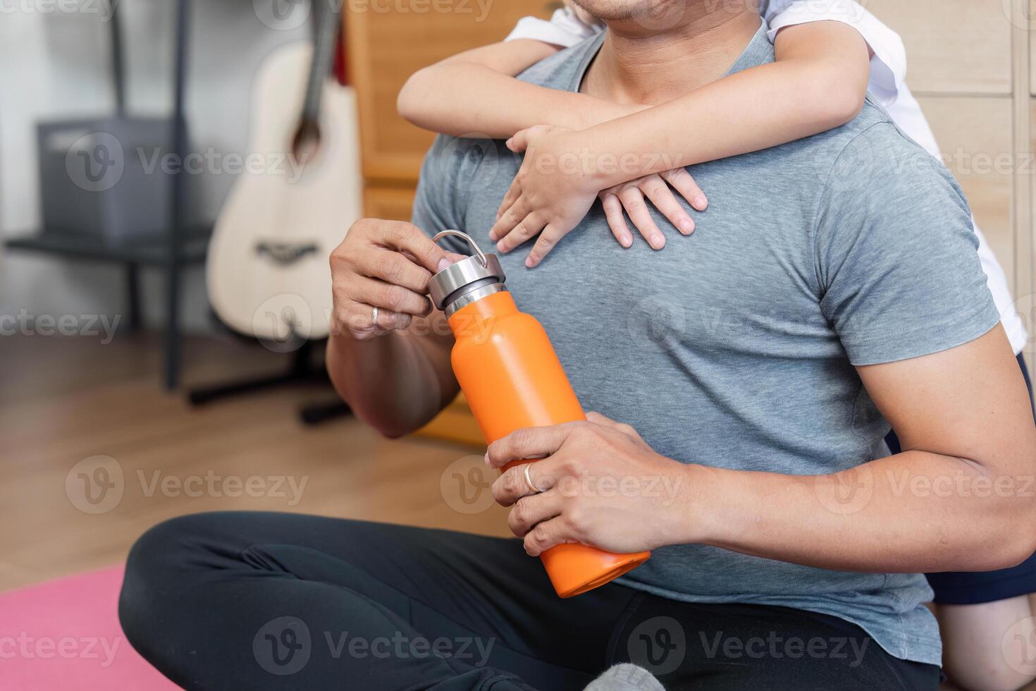 Family love captured with son hugging father during workout break photo