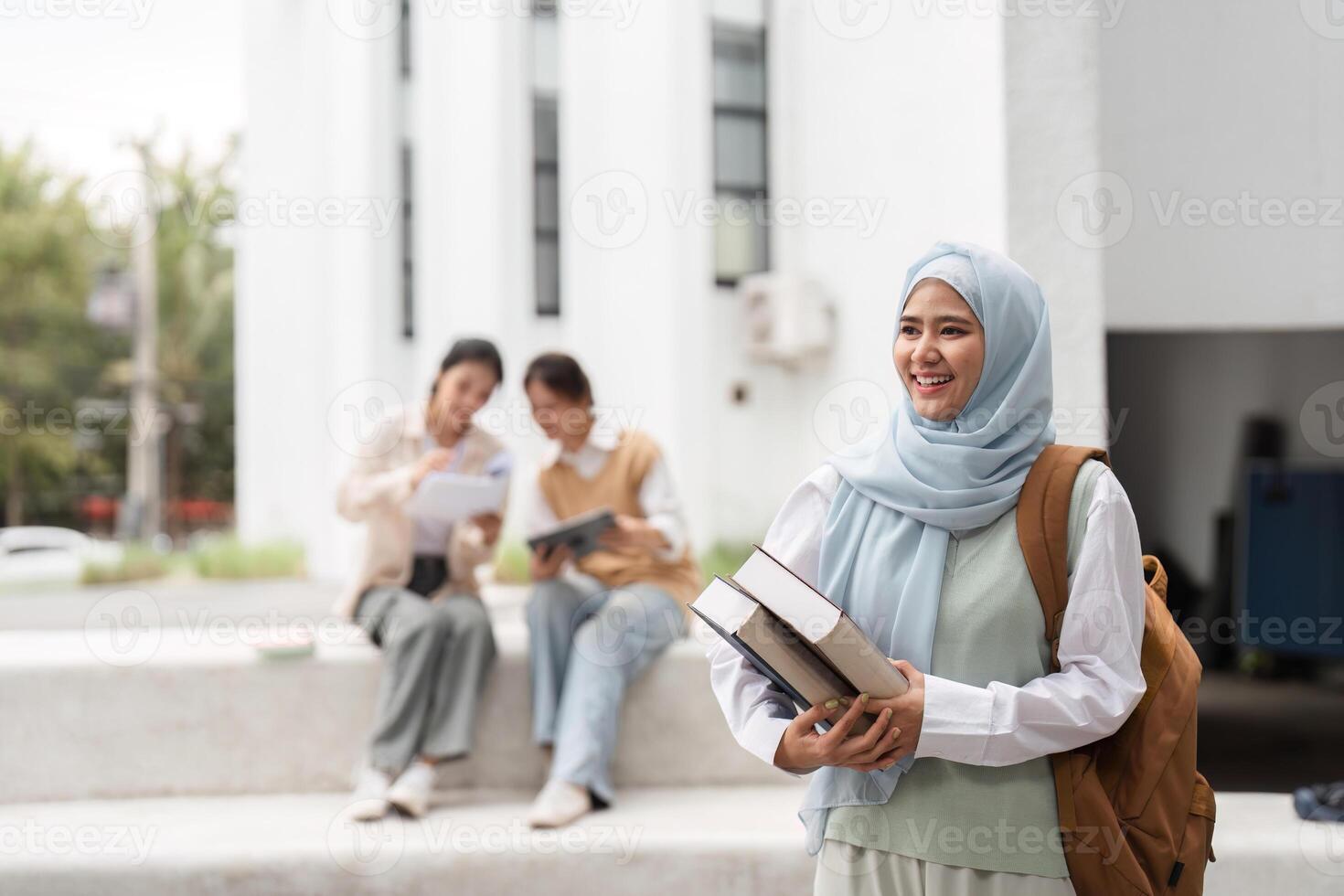 Diverse female student carrying books and smiling on a university campus. photo