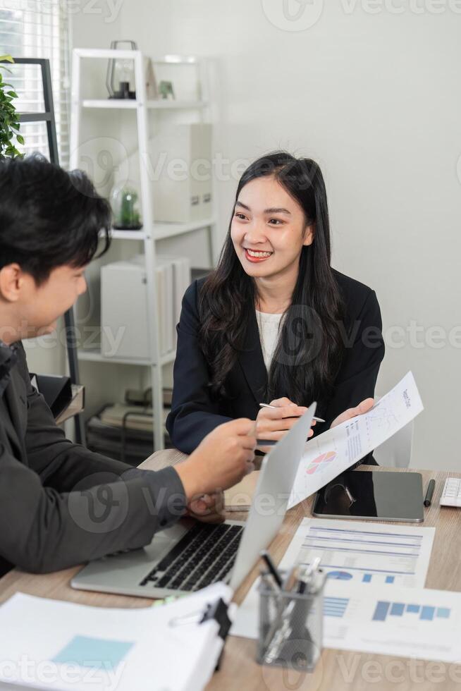 Diverse business colleagues discussing charts and data analysis in a contemporary office setting. photo