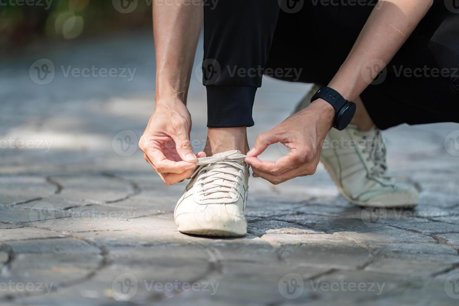Wellness and Preparation. Close-up of a person tying shoelaces before exercise. photo