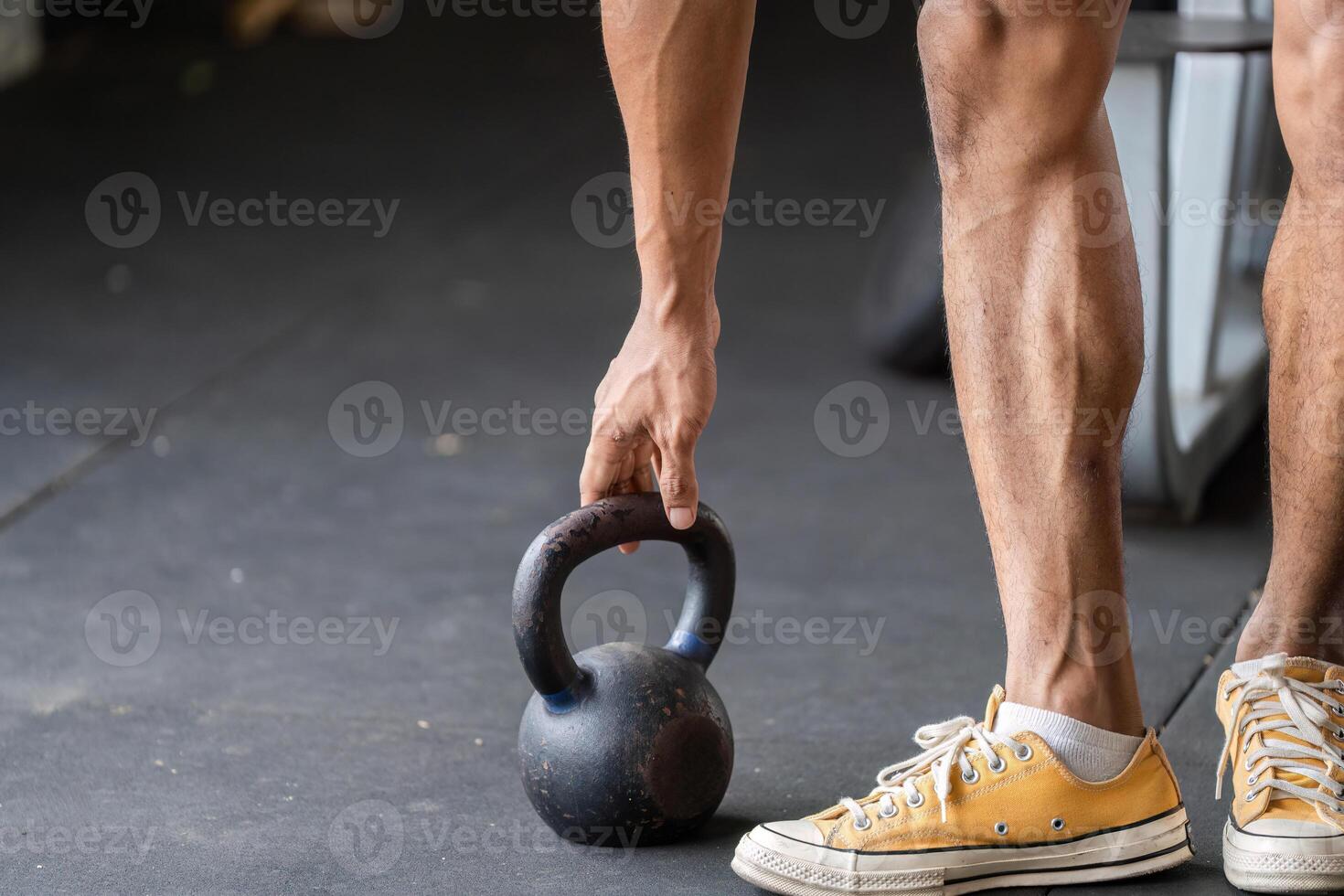 Kettlebell Exercise. Athlete preparing to lift kettlebell in gym setting. photo