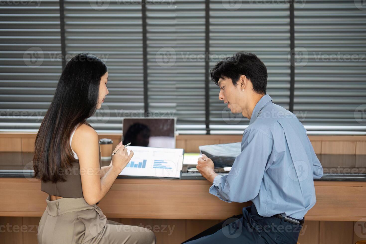 Business Analysis and Consultation. Professionals reviewing data in a modern office setting. photo