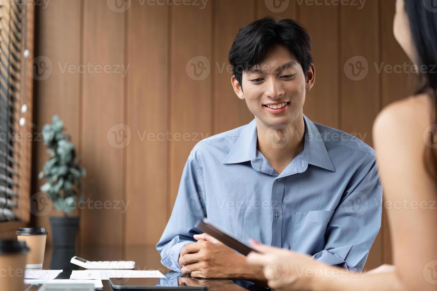 Business Meeting and Collaboration. Young professionals discussing financial reports in a modern office. photo