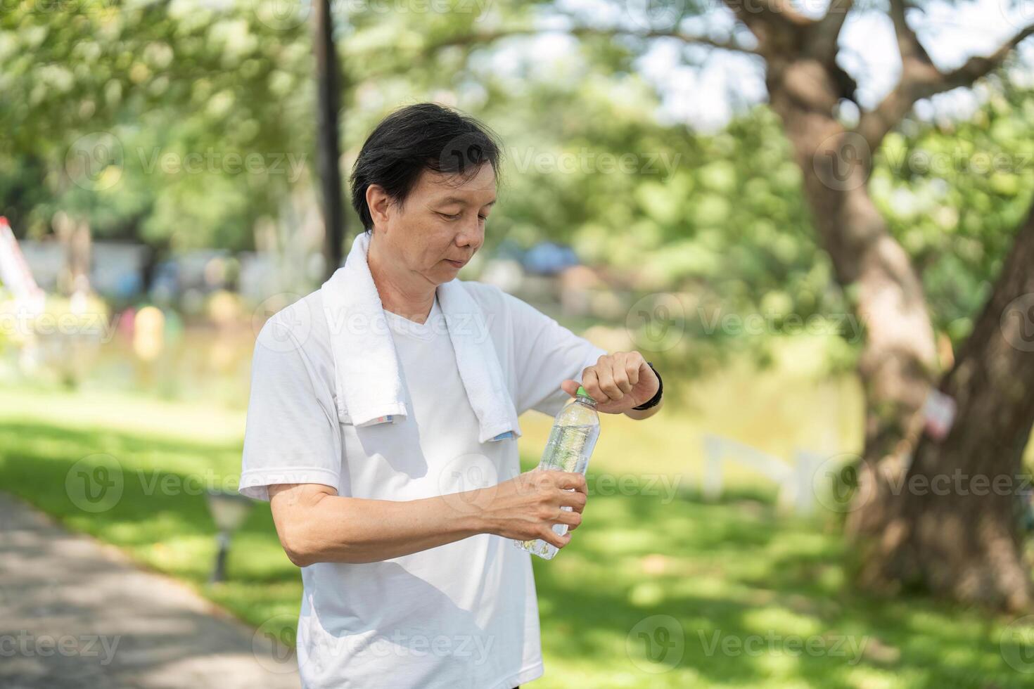 Wellness and Hydration. Man preparing to drink water after exercise. photo
