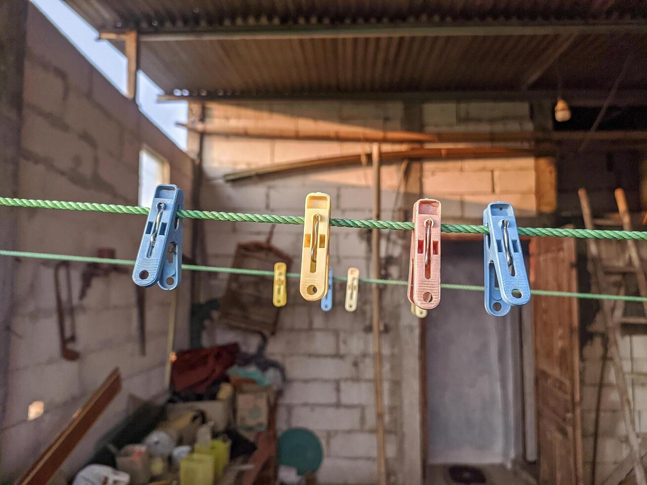 Colorful Clothespins Hanging on a Green Clothesline photo