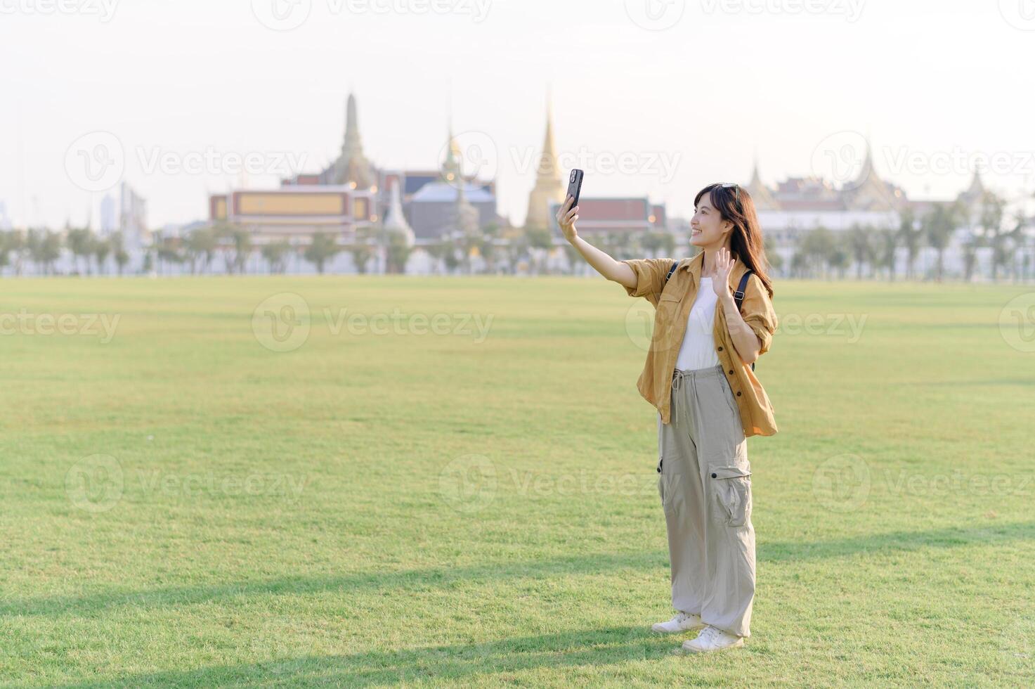 Asian woman taking selfie in park photo