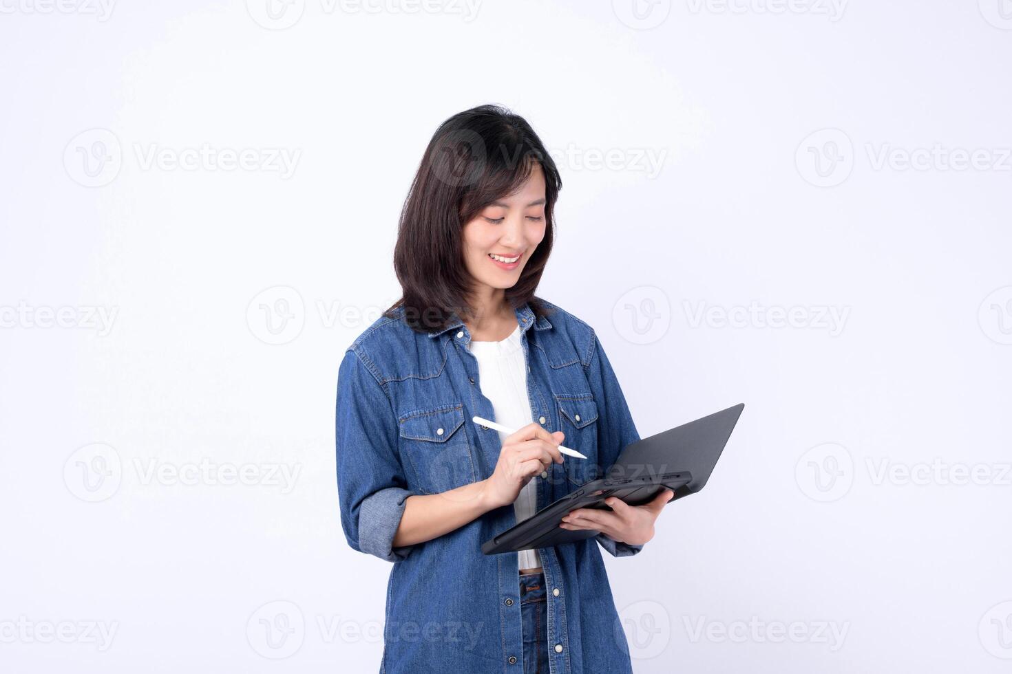 Southeast asian woman is small business owner working creatively on her online store using digital tablet in retail and startup industry with happy expression photo