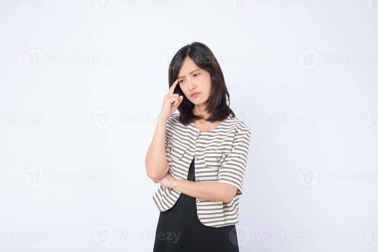 Southeast asian woman in striped jacket looks thoughtful and confused while advertising concept of decision making or problem solving photo