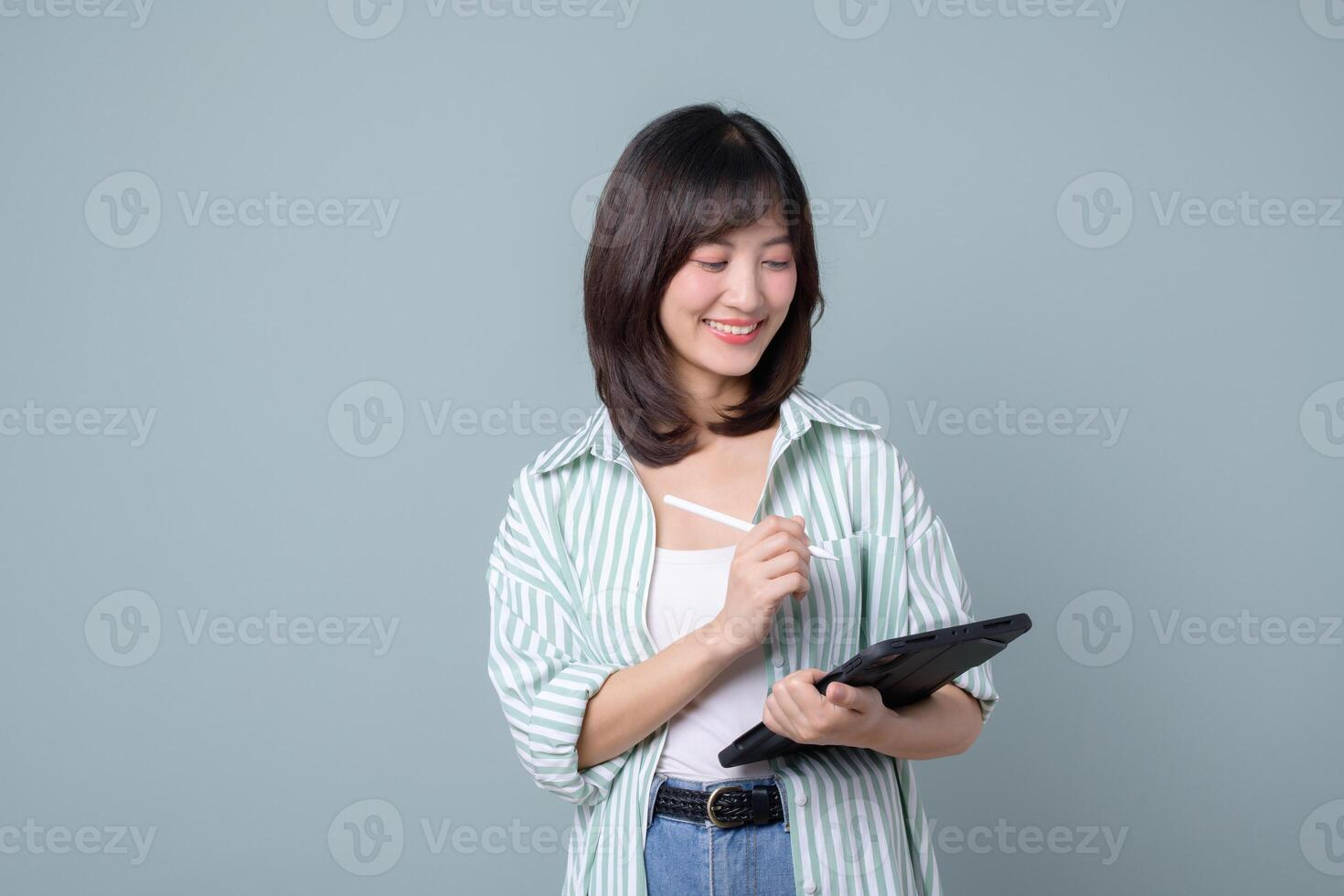 Southeast asian woman is small business owner working creatively on tablet for her online retail store startup in shopping and creative industry with happy expression photo