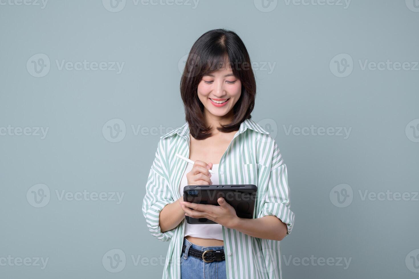 Southeast asian woman is small business owner working creatively on tablet for her online retail startup store in shopping and creative industry with happy expression photo