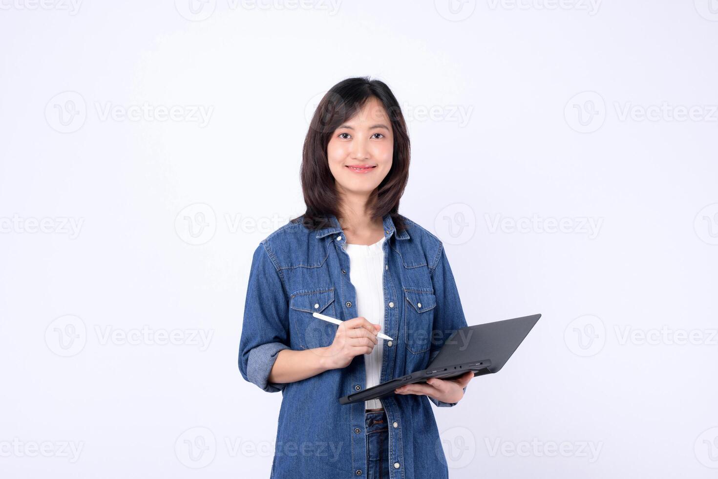 Southeast asian woman small business owner is creatively working on her online store using laptop in retail and startup industry with confident and happy expression photo