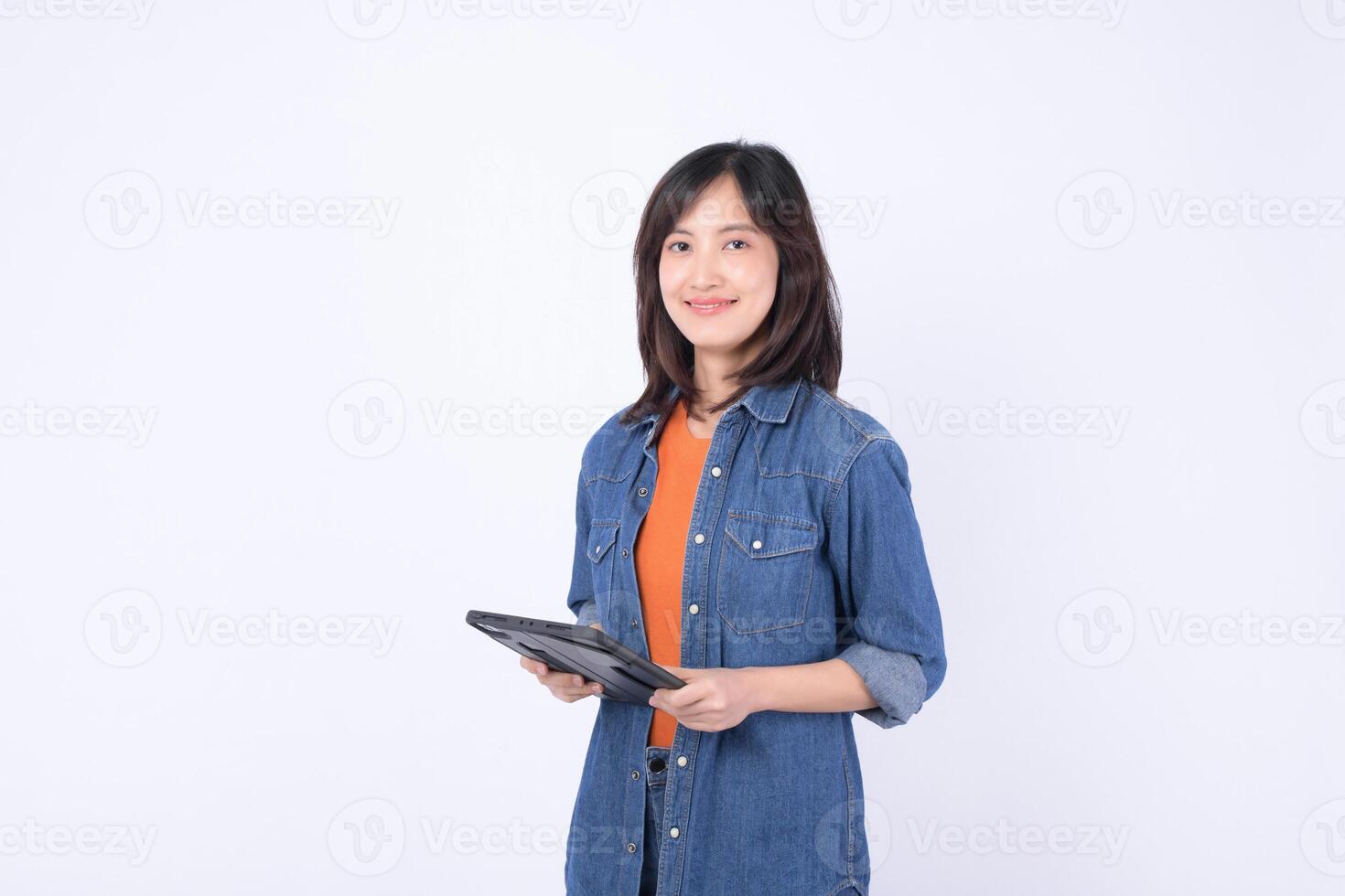 asian woman is small business owner working creatively in retail industry using tablet for her online store startup with confident and happy expression photo