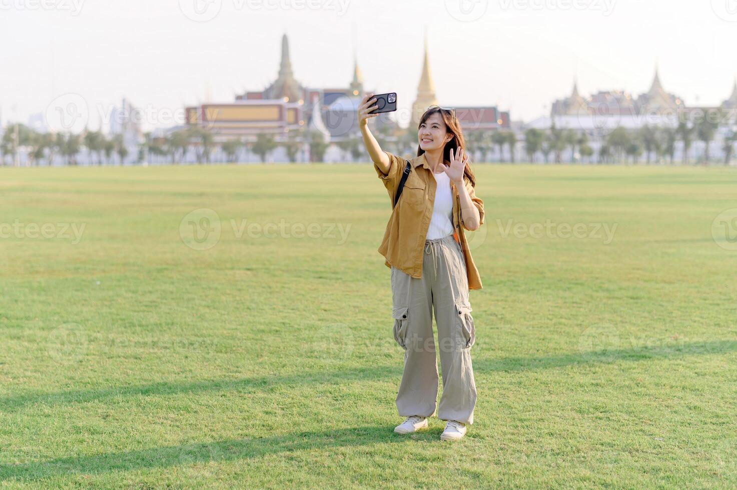 A woman taking a selfie in front of a building photo