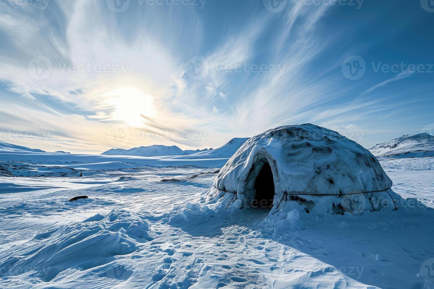 A beautifully sculpted igloo amidst the winter wilderness, glowing softly against the snow. photo
