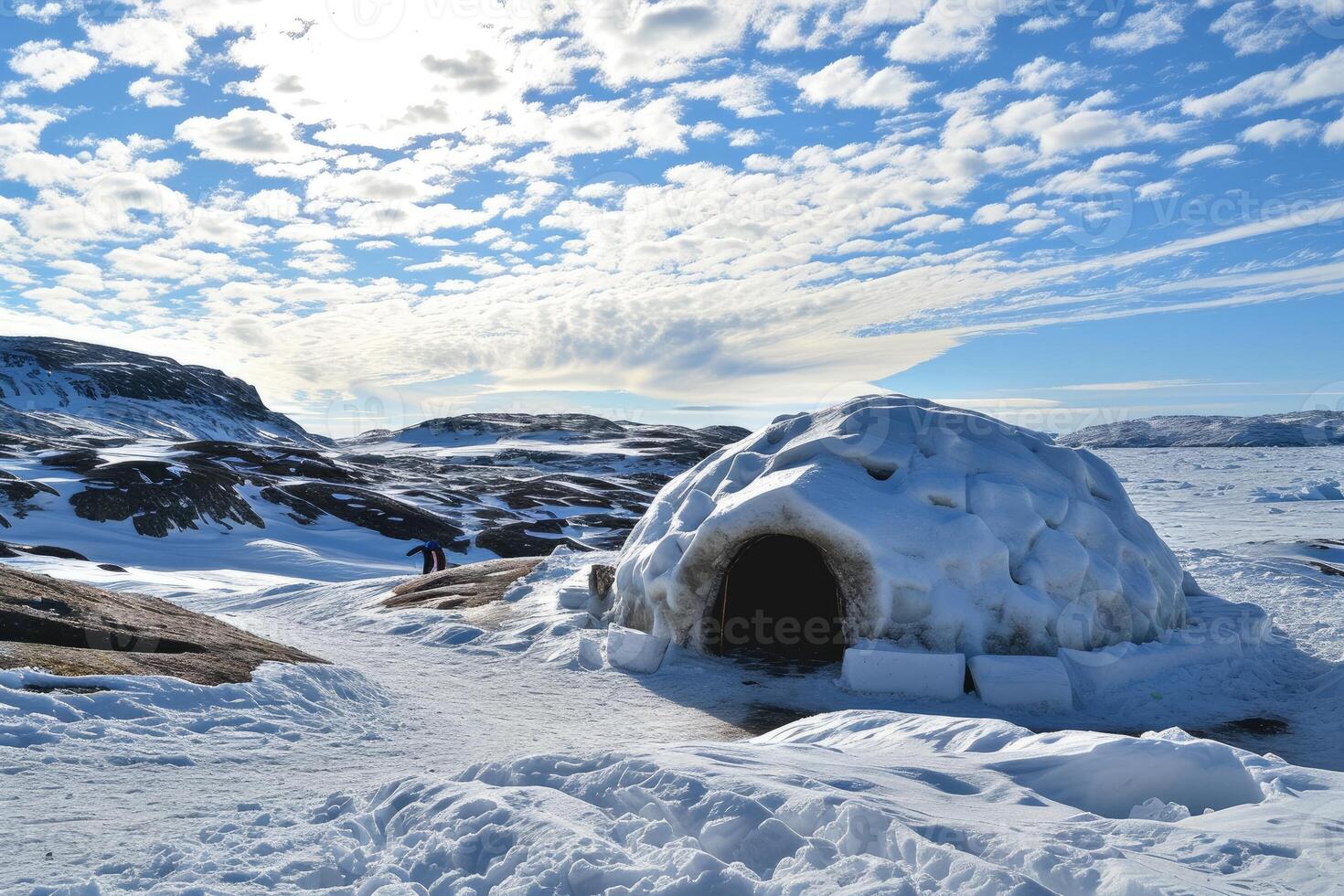 An Inuit dwelling in the form of a glistening igloo, resting under a deep blue night sky. photo