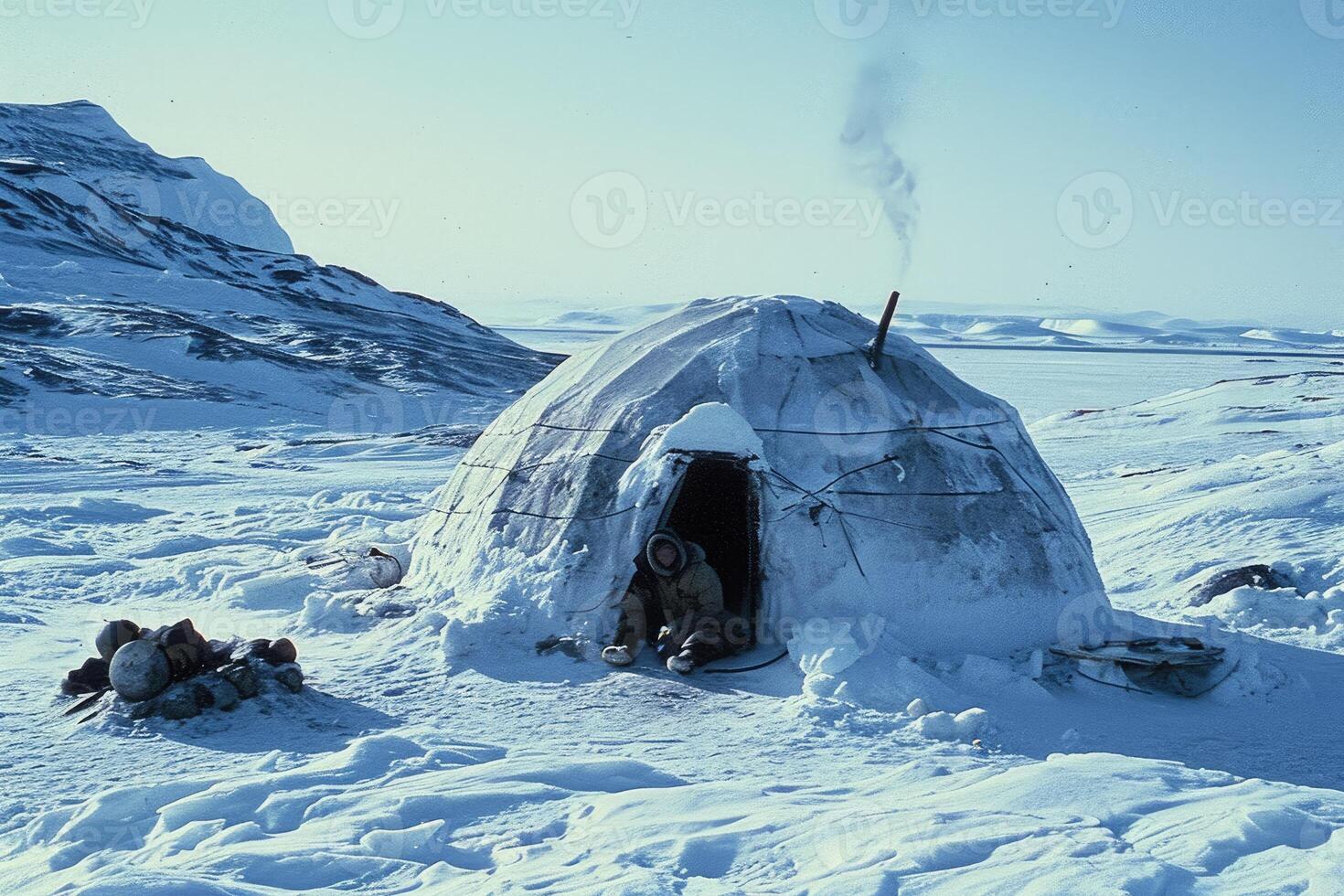 A traditional igloo settlement in the Arctic, bathed in the soft glow of lantern light. photo