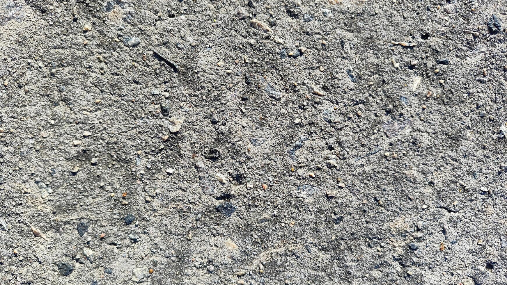 rough concrete and stone texture background, a natural and gritty surface for industrial and urban design projects photo