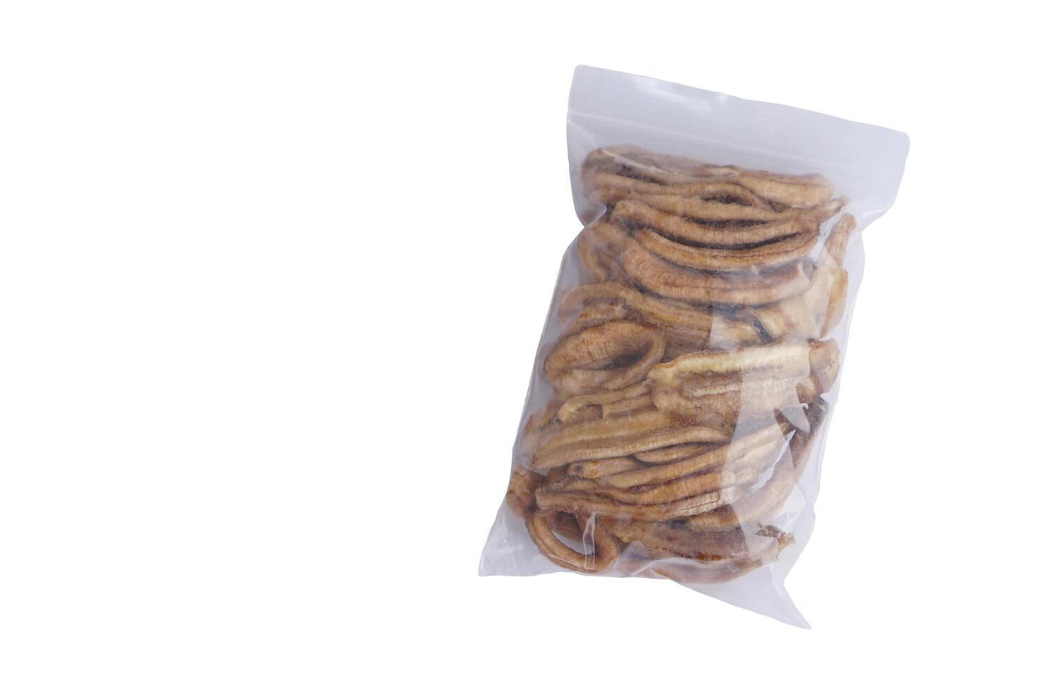 Dried banana snack in zip locked bag, isolated on white background. Concept, healthy natural snack, no added sugar, perfect for clean eating lifestyles health conscious consumers. photo