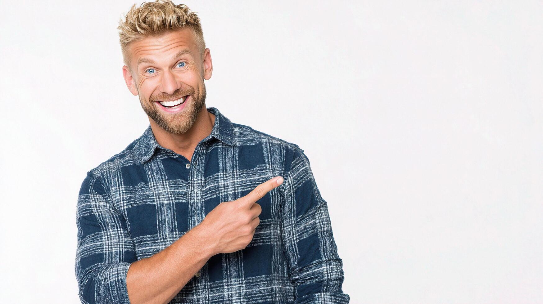 A man with a beard and a plaid shirt pointing at something photo