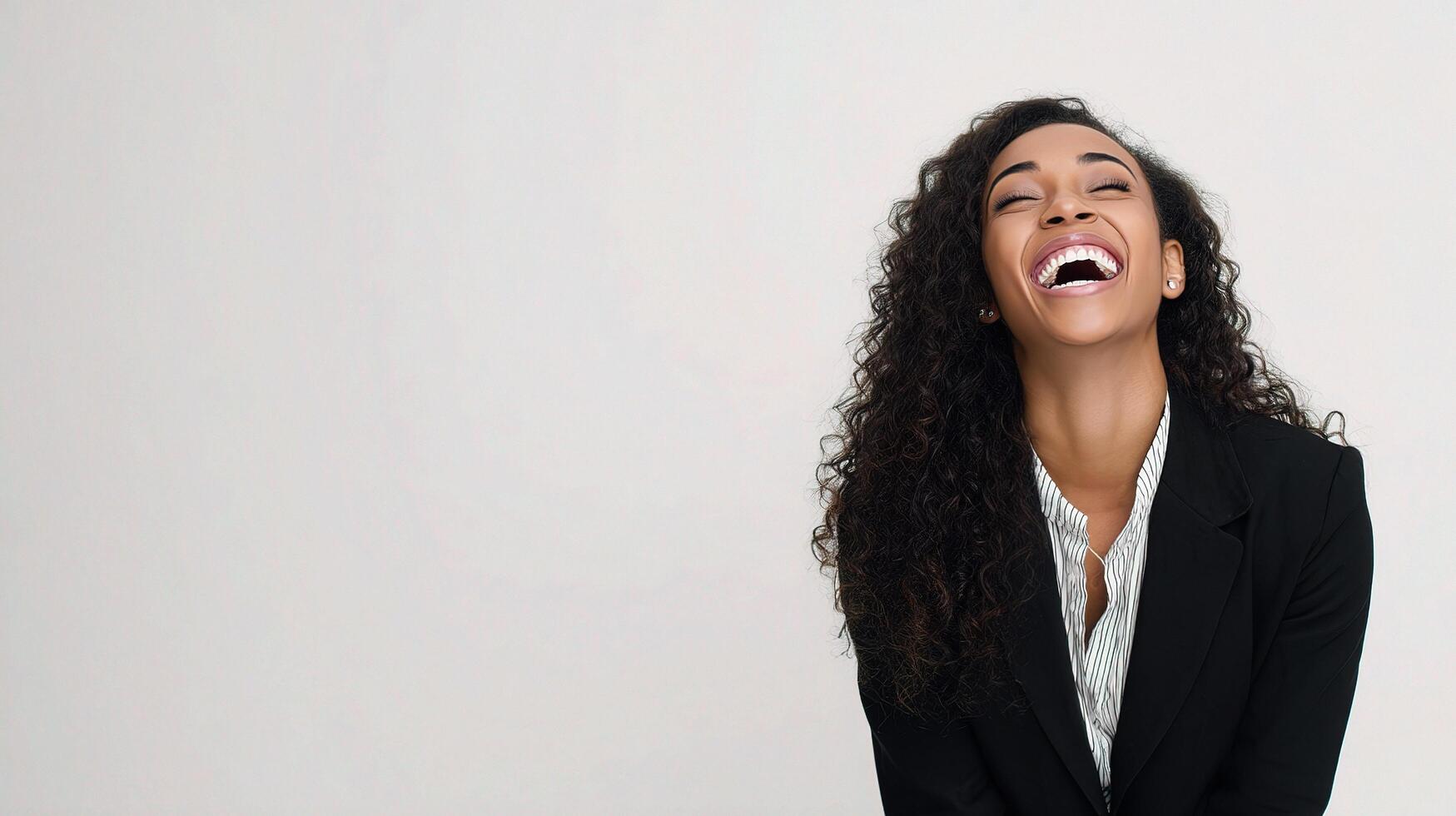 A woman laughing in a suit and tie photo
