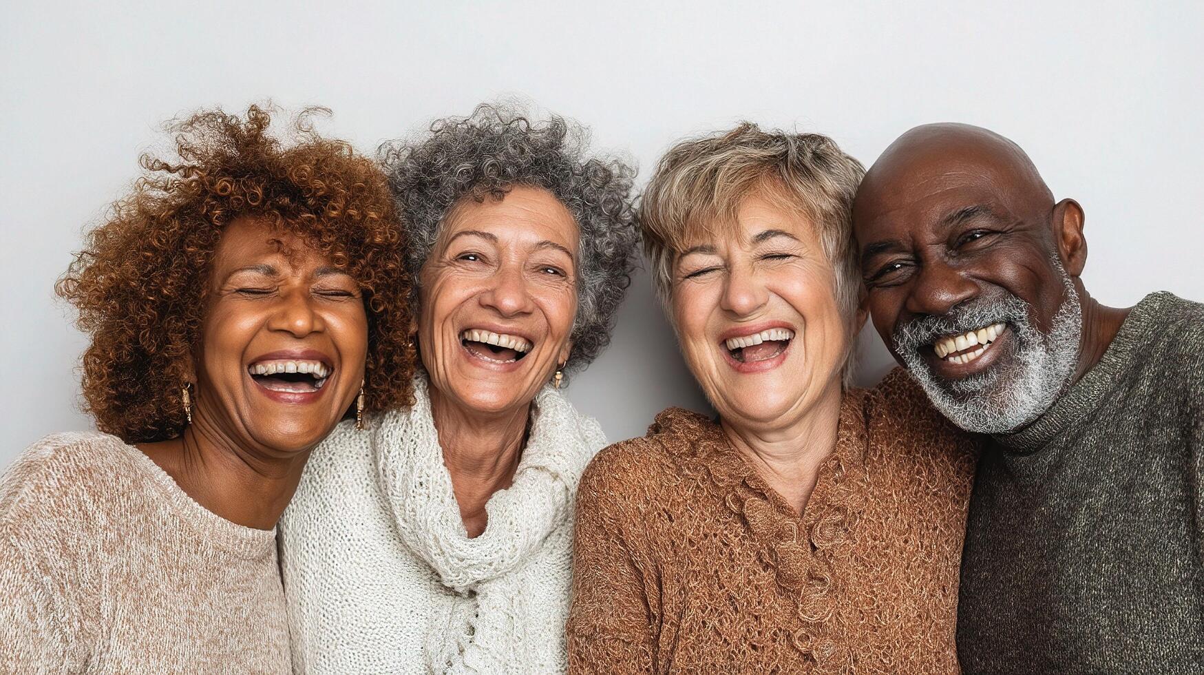 Four older adults laughing together photo