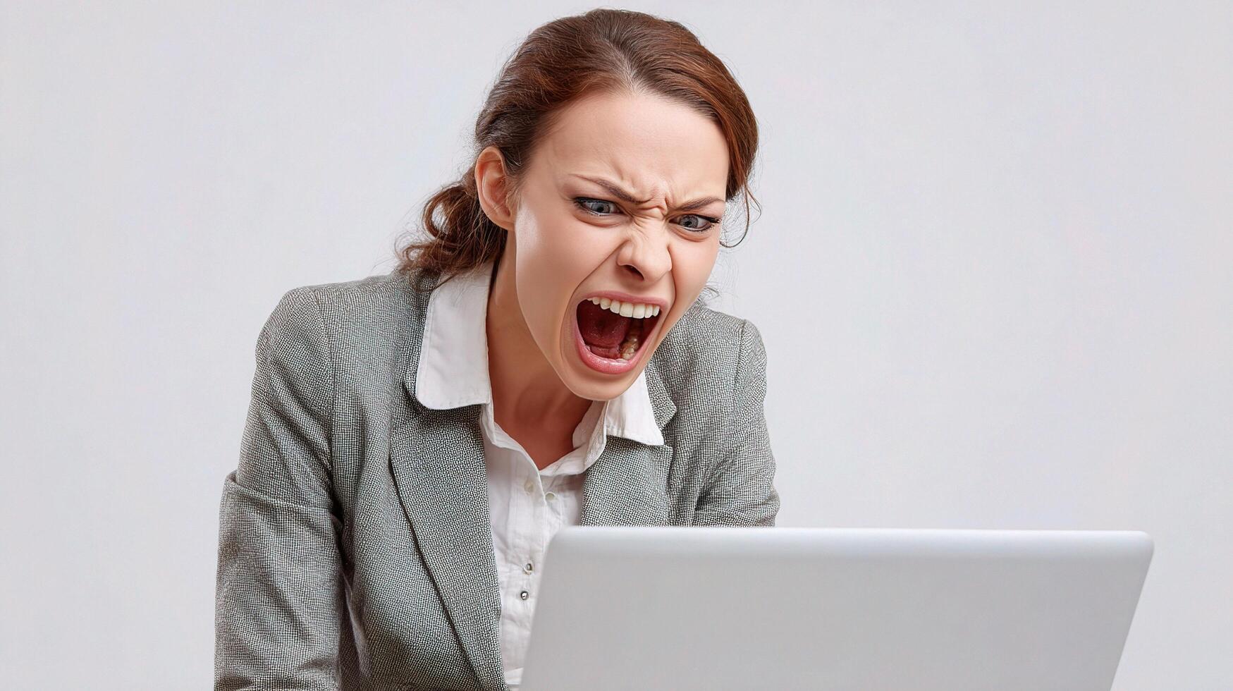 A woman screaming at her laptop photo