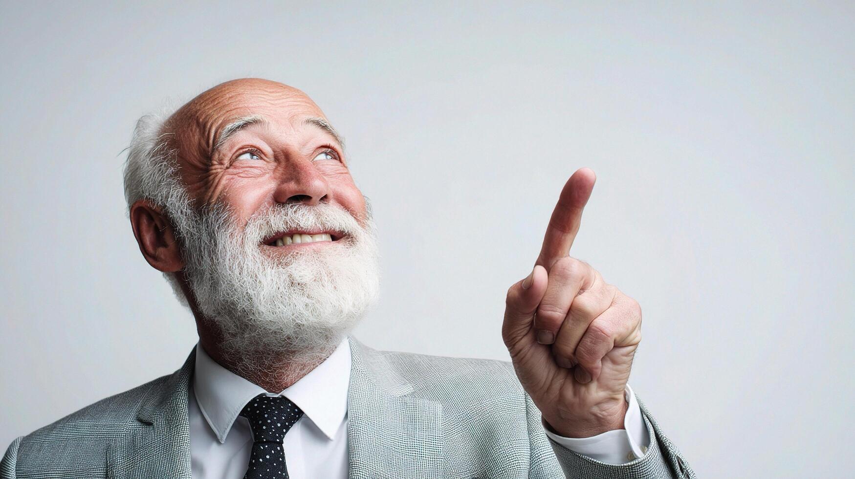 An older man with a white beard pointing up photo