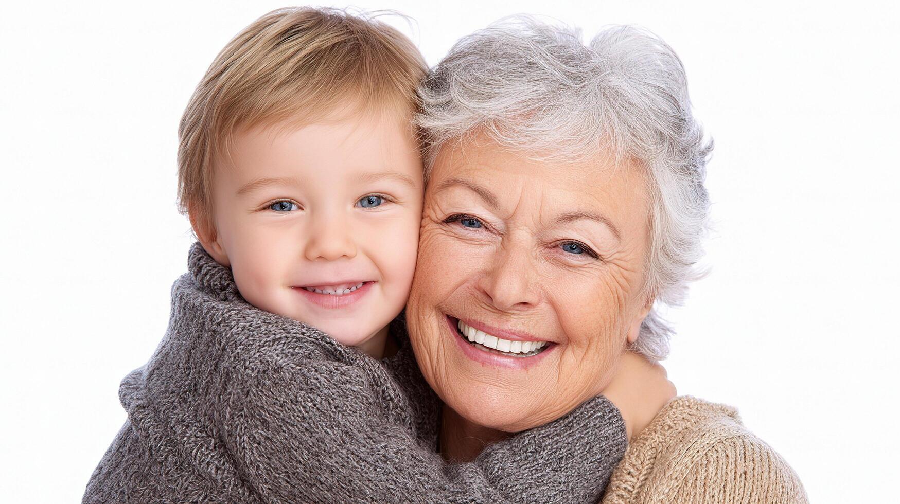 A smiling older woman holding a young child photo