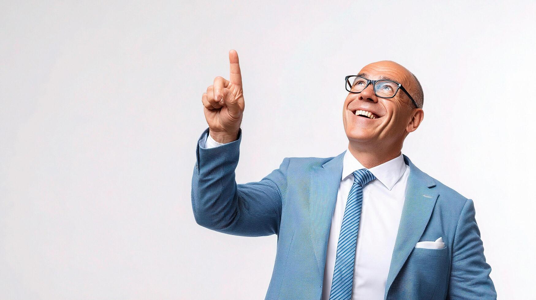 A bald man in a suit and glasses pointing up photo