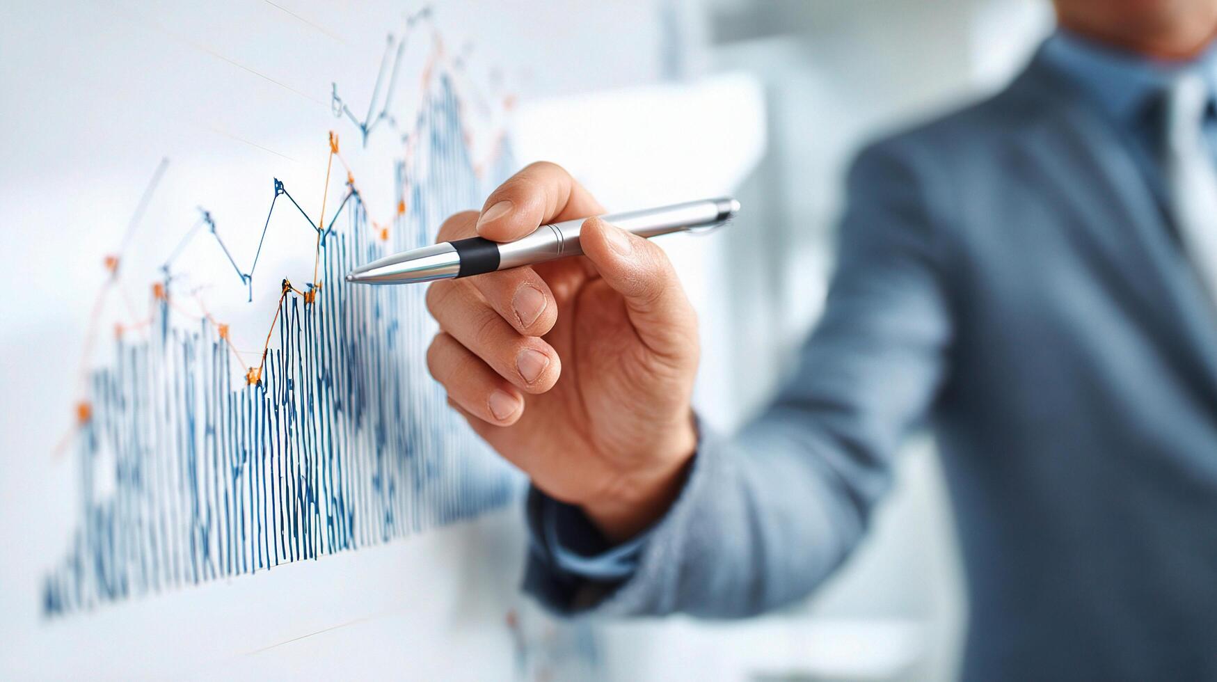 A man in a suit is drawing on a whiteboard with a pen photo