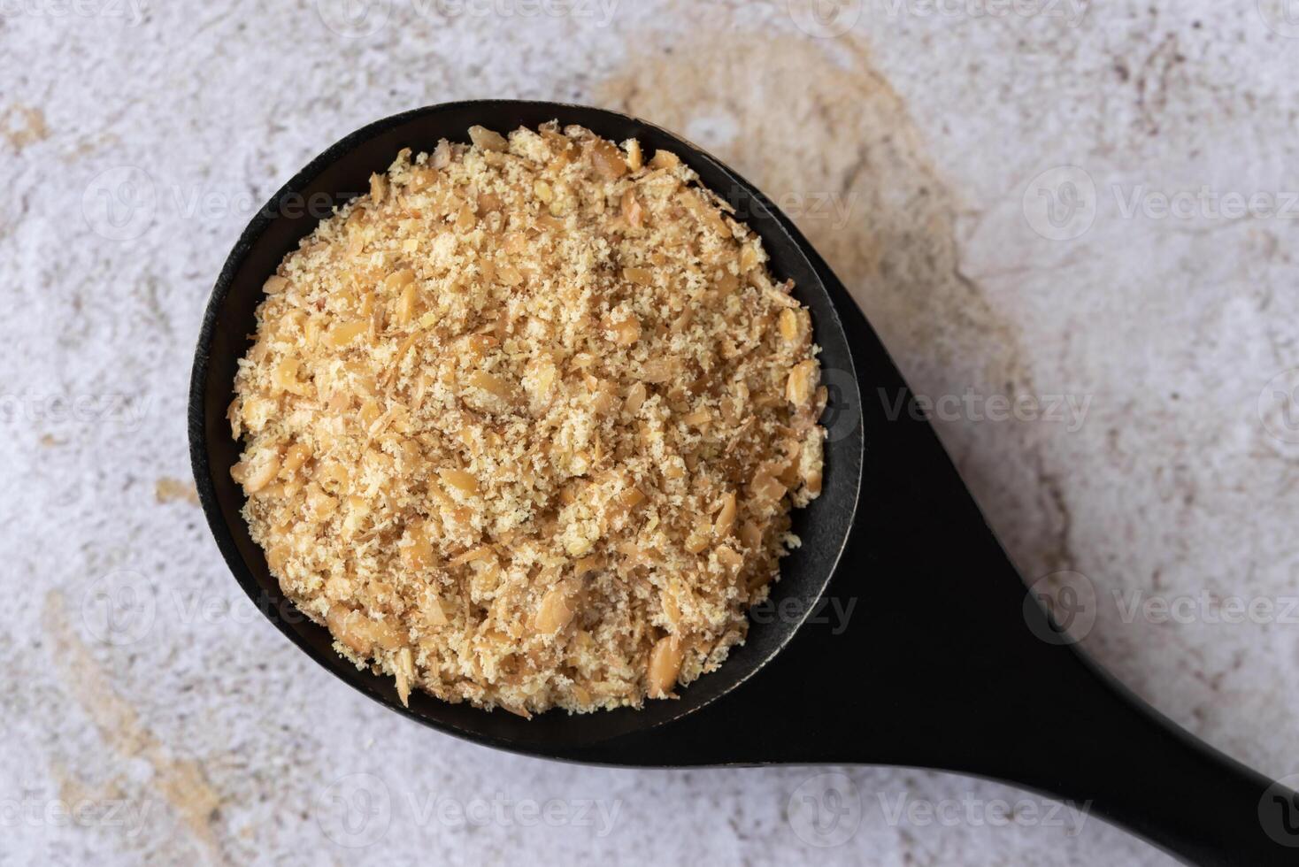 Flaxseed Meal on a Black Spoon photo