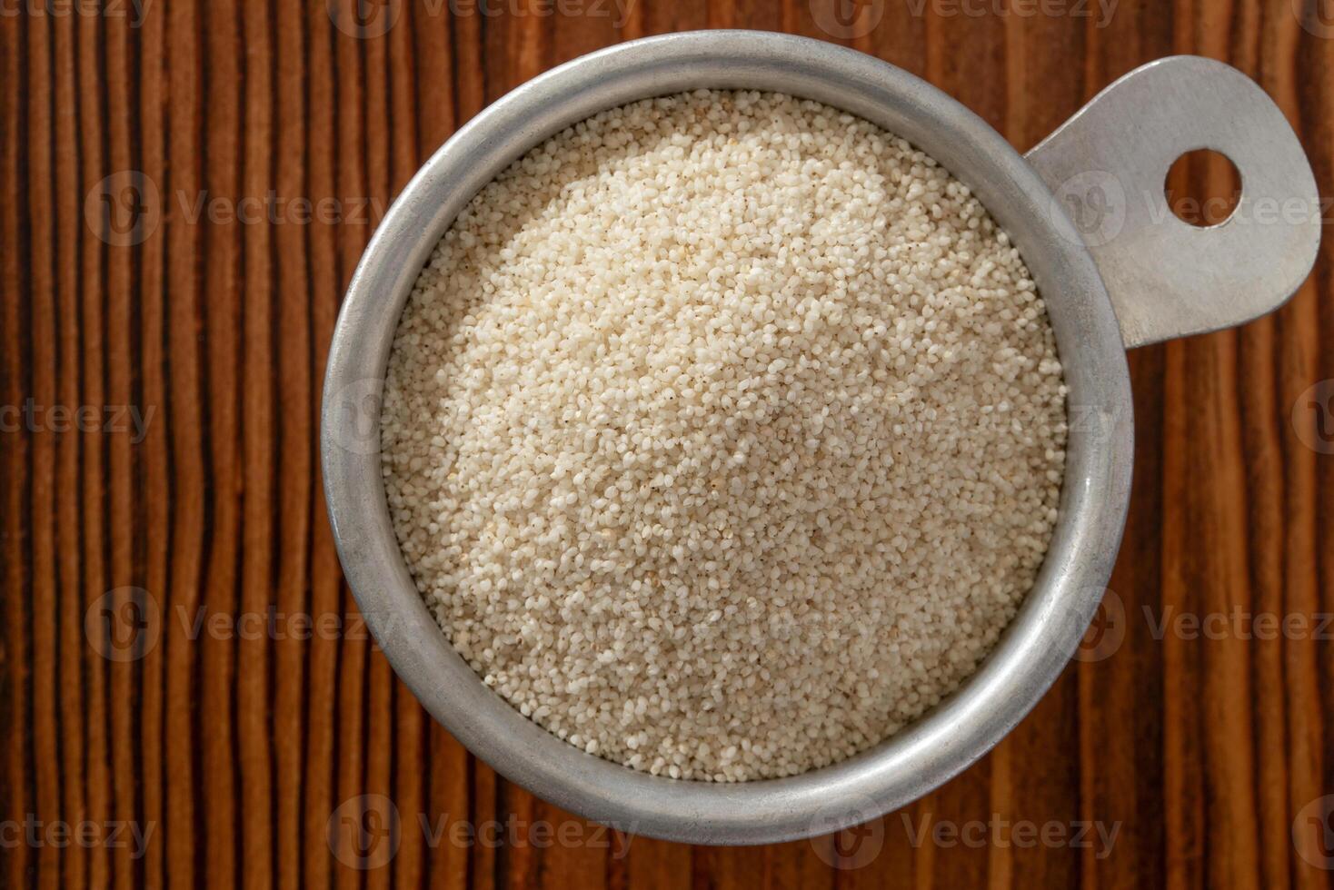Uncooked Fonio Grain in a Vintage Measuring Cup photo