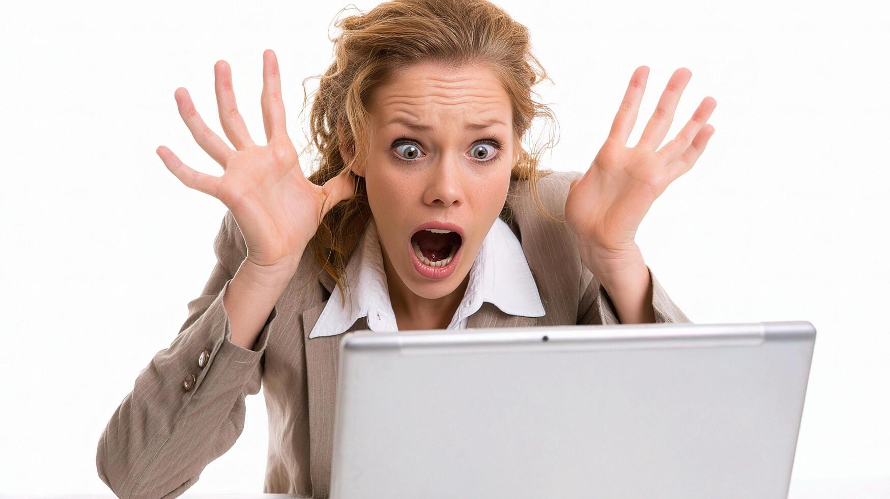 A woman with her hands up in front of a laptop photo