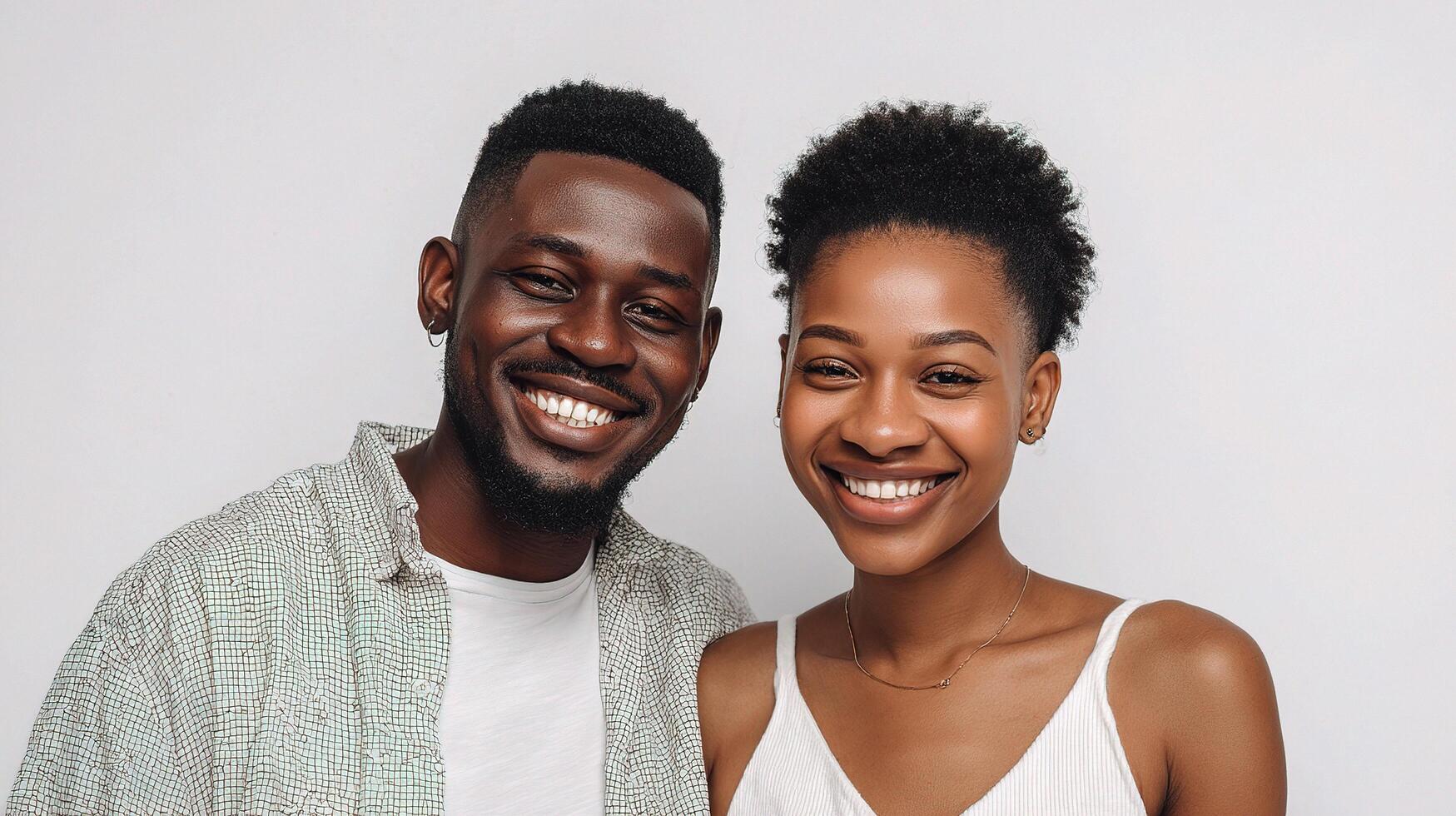 A young couple smiling and posing for the camera photo