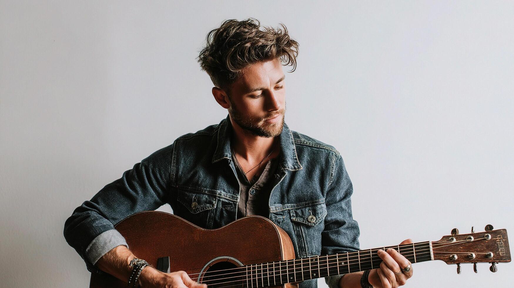 A man with a guitar is playing it photo