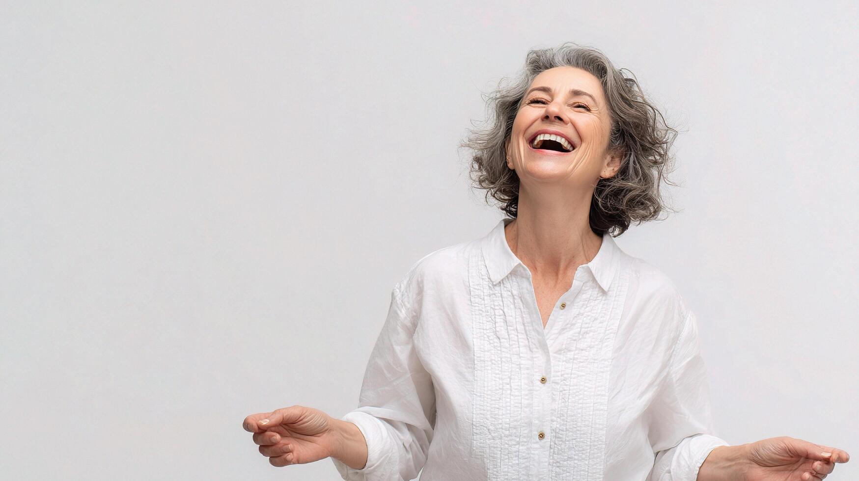 A woman laughing and smiling on a white background photo