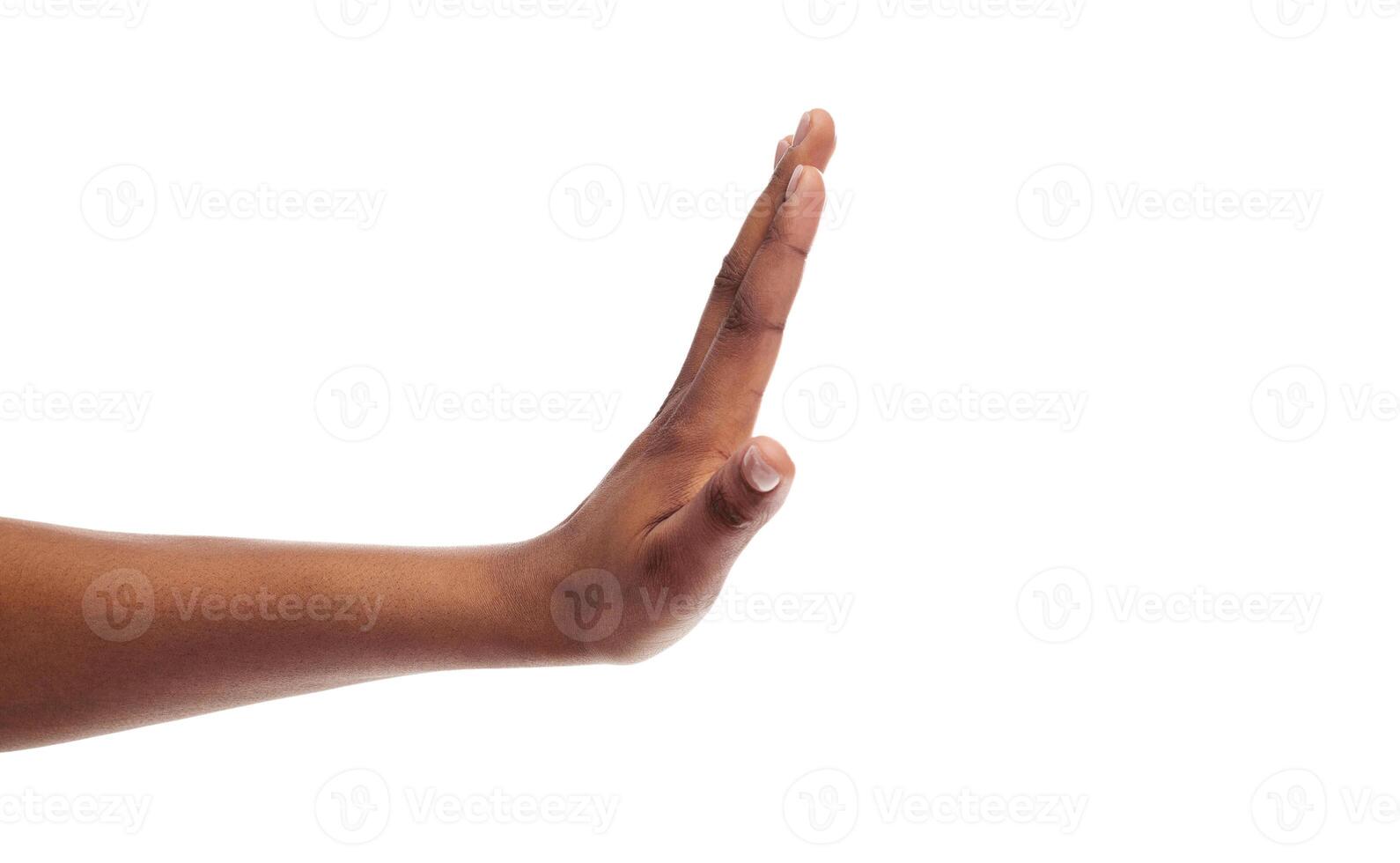 Side view of black female hand showing stop gesture, isolated on white background, copy space photo