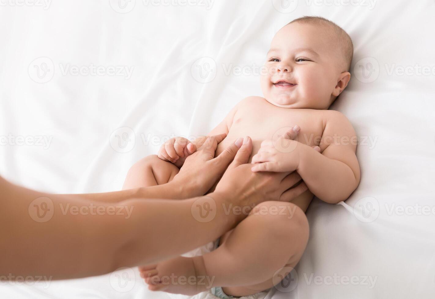Colics prevention. Masseur massaging tummy of newborn baby, healthcare and babycare, copy space photo