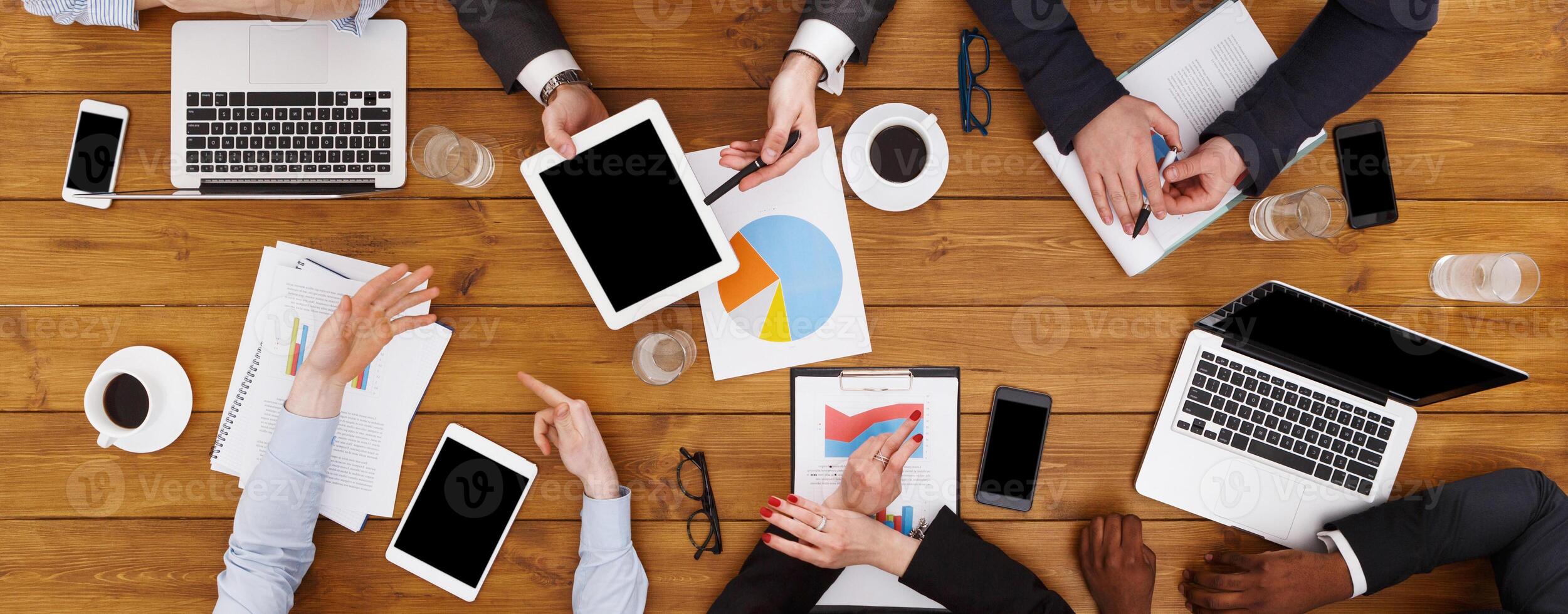 Business meeting top view. Multiethnic busy people work in office photo