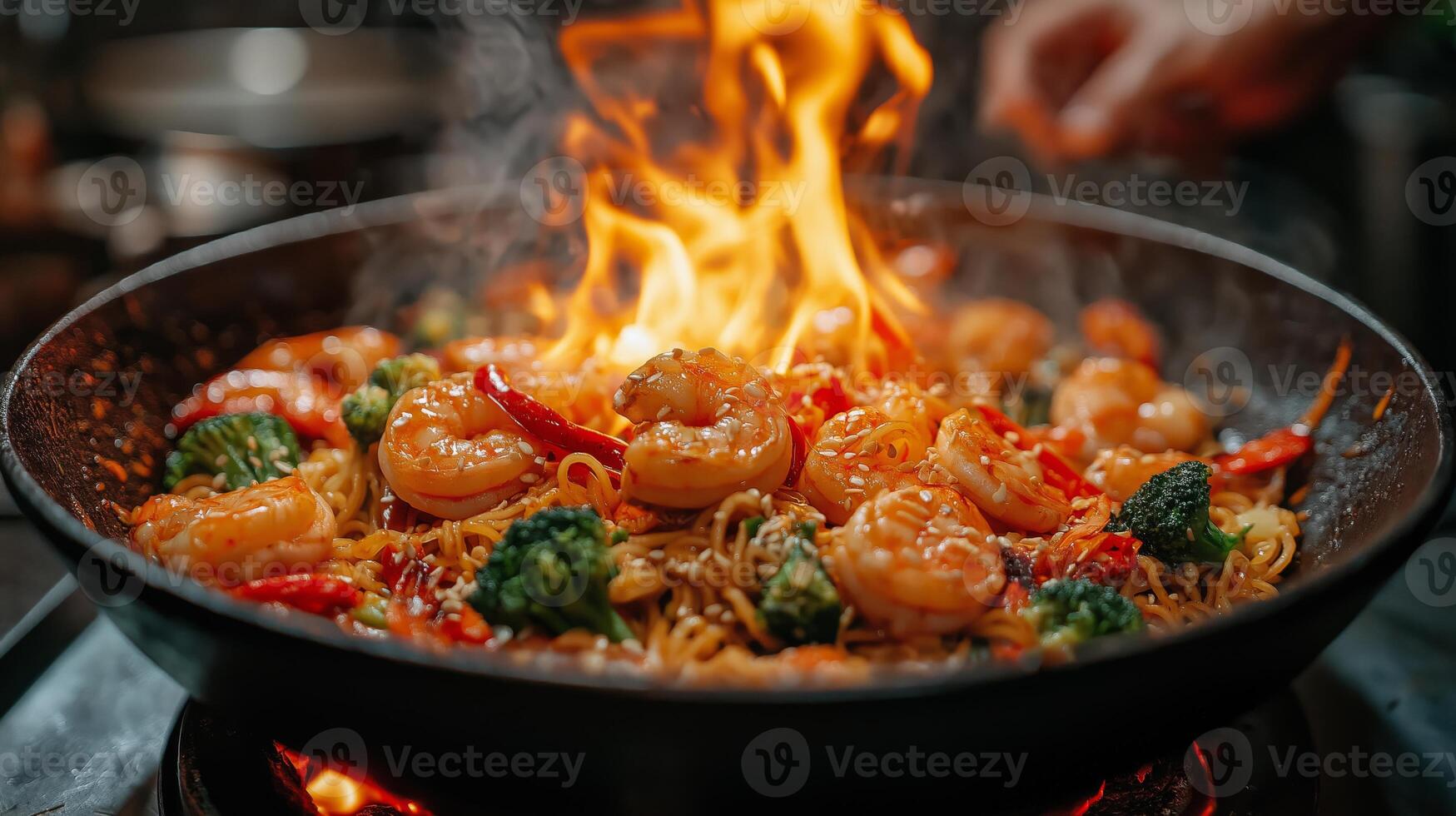 Shrimp and vegetables sizzle in a hot wok, flames leap from the pan while a chef stirs the dish, filling the kitchen with rich aromas during dinner preparation. photo
