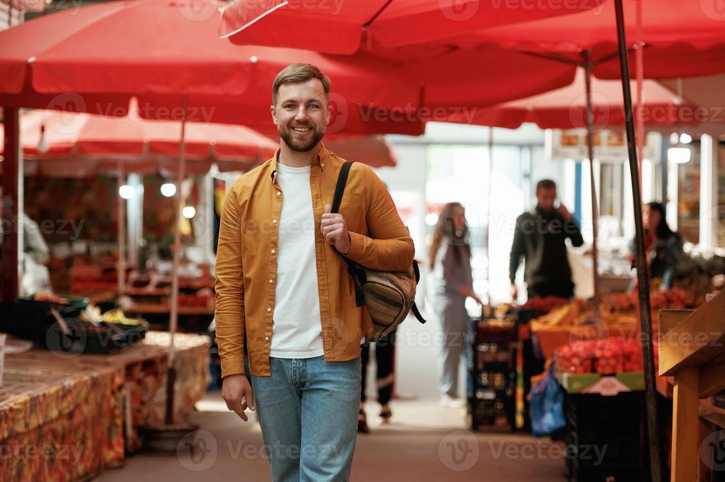 Front view, walking. Handsome man is on the street market or,, bazaar photo