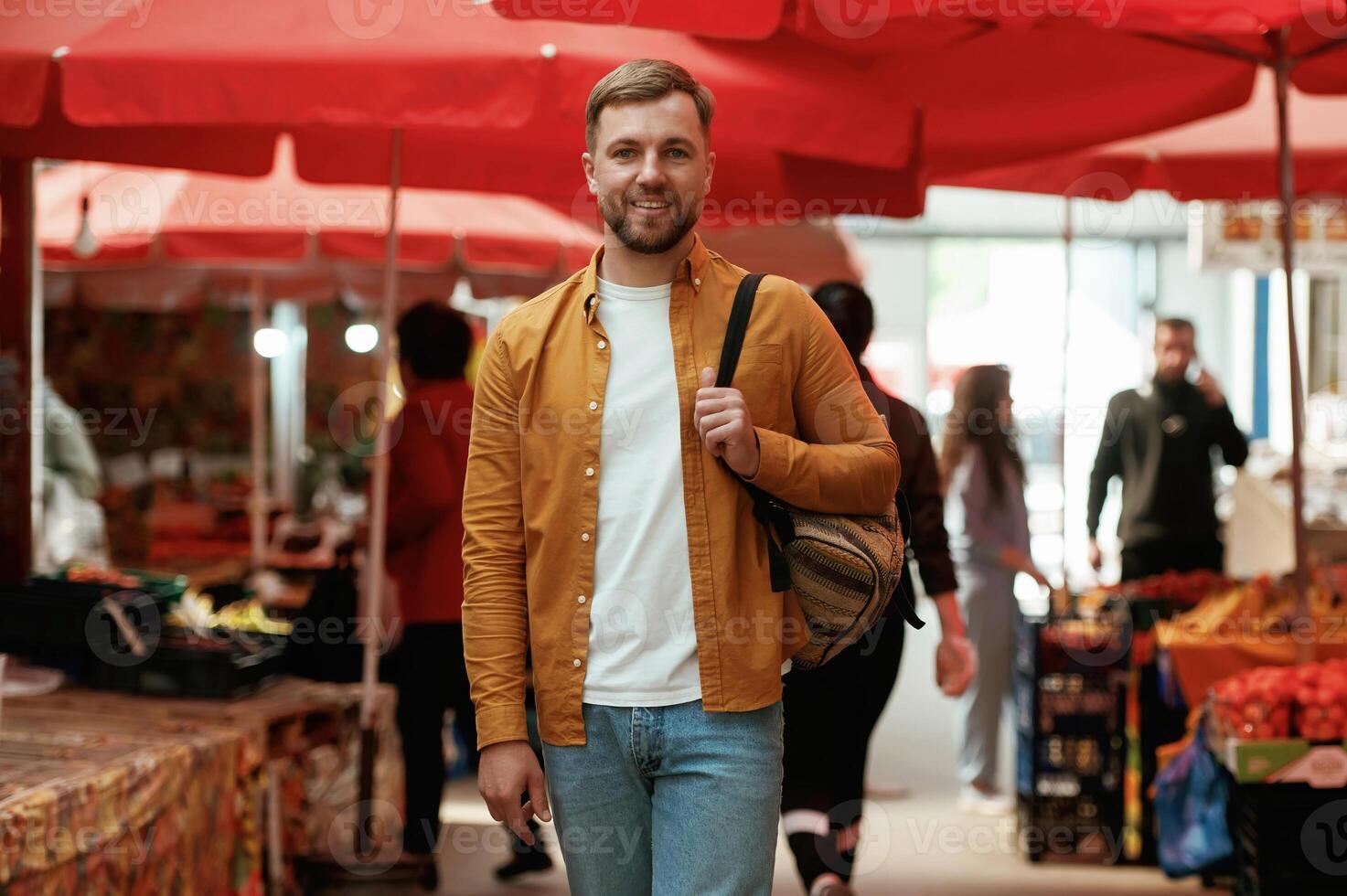 Front view, walking., Handsome man is, on ,the street market or bazaar photo