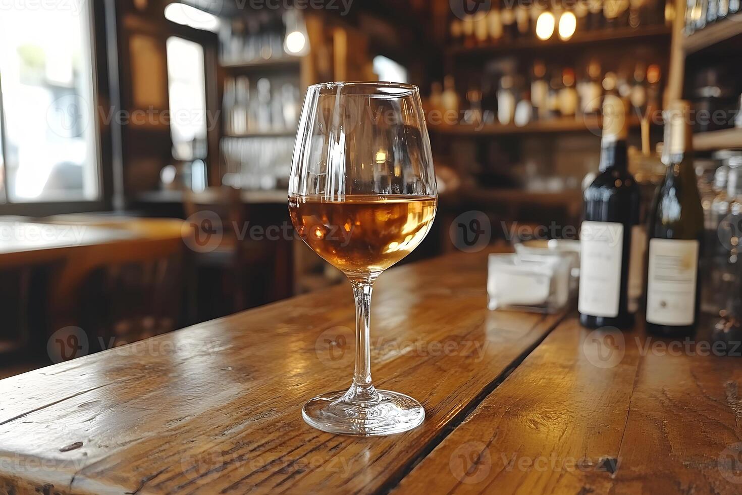Elegant Wine Glass on Rustic Bar Table in Cozy Tavern Environment photo
