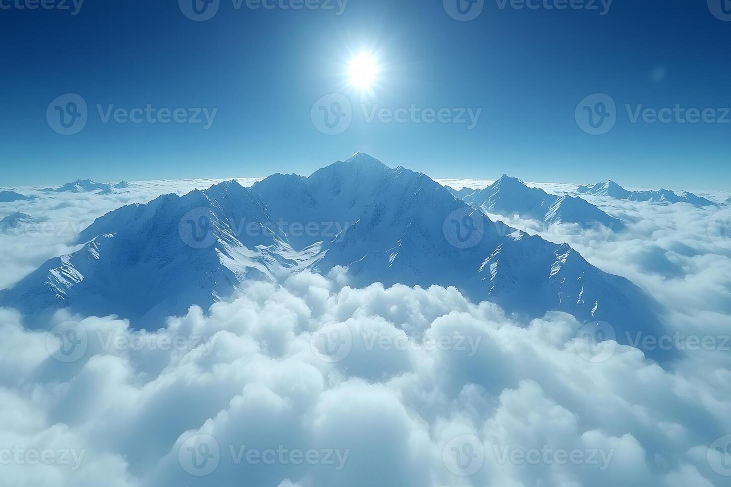 Majestic Snow-Capped Mountain Peaks Emerging Through Clouds at Sunrise photo
